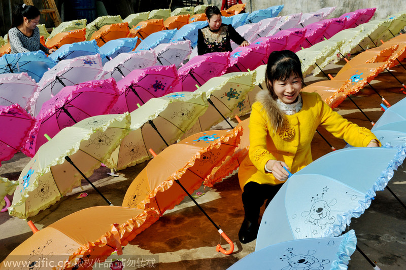 Women make umbrellas for export in Jiangxi