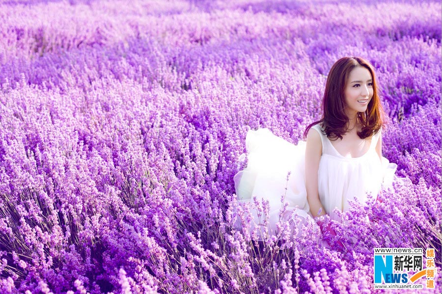 Tong Liya poses in blooming lavender flowers