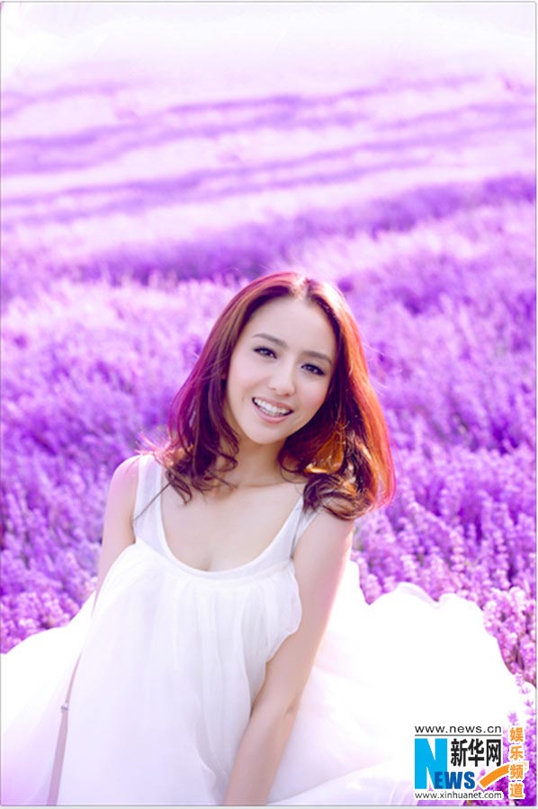 Tong Liya poses in blooming lavender flowers