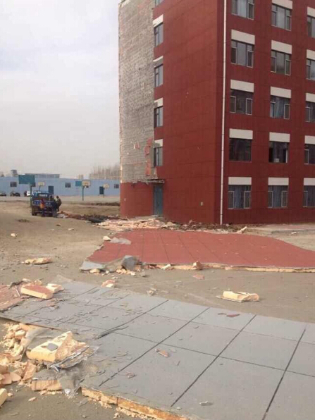 Outer wall of college dorm crumbles under average winds