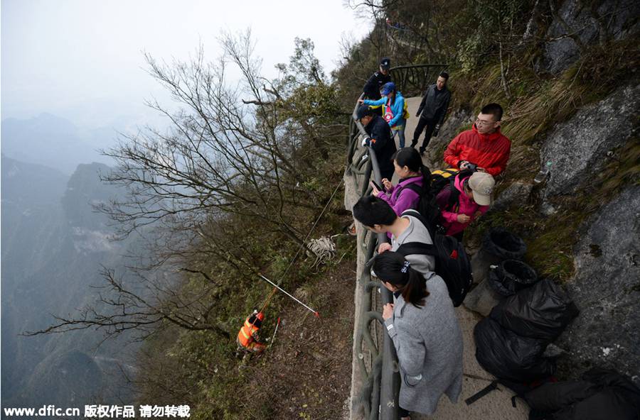 'Spider-men' janitors clean up mountain