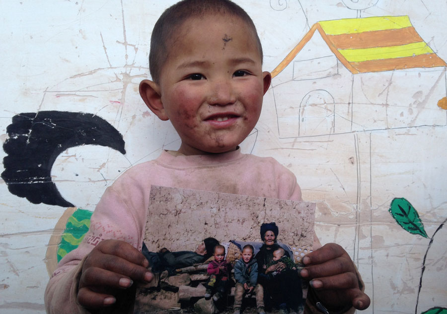 Young photographer takes family photos for mountain-dwellers