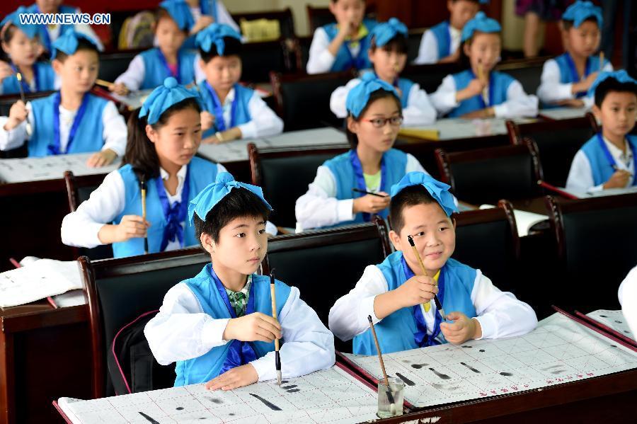 Children study calligraphy during summer class