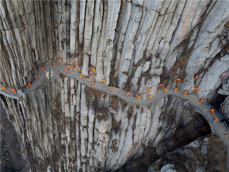 Martial artists practice Shaolin kung fu on cliff