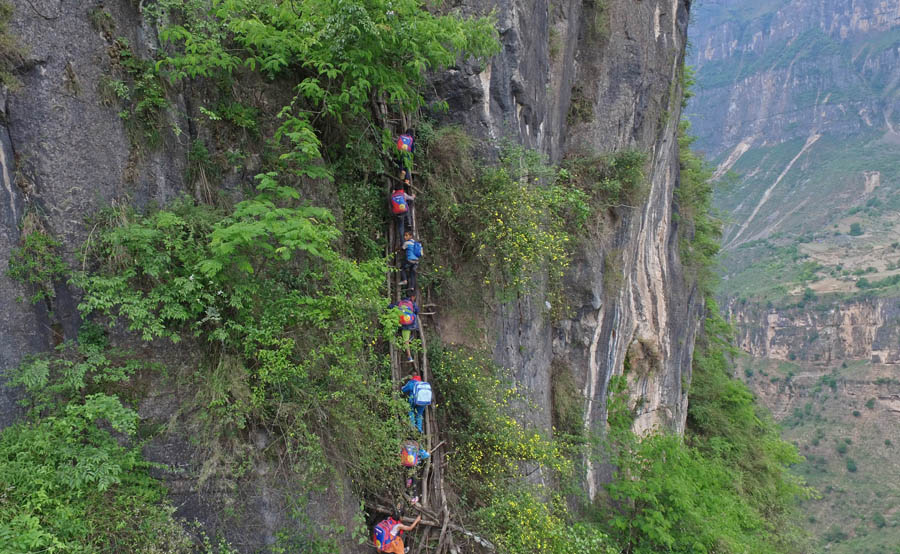 Children scale 800-meter cliff on way to school