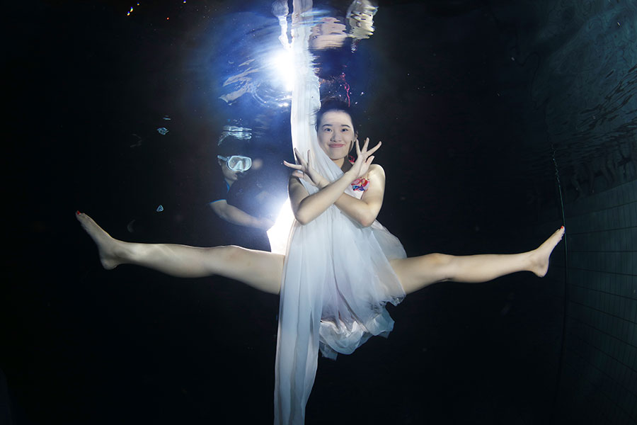 University students go underwater to celebrate graduation