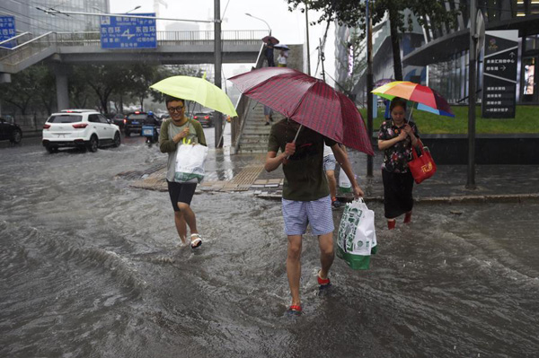 Beijing issues orange alert for heavy rain, train, flights delayed