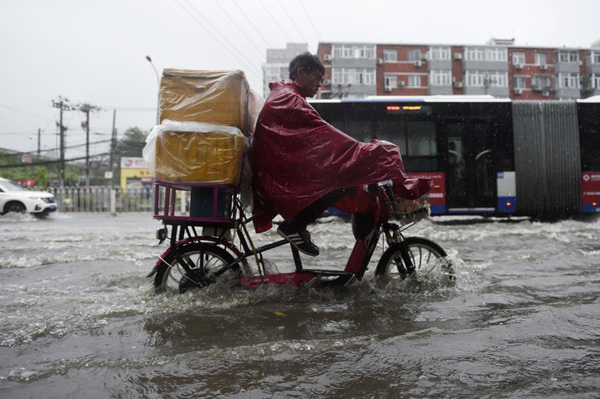 Beijing issues orange alert for heavy rain, train, flights delayed