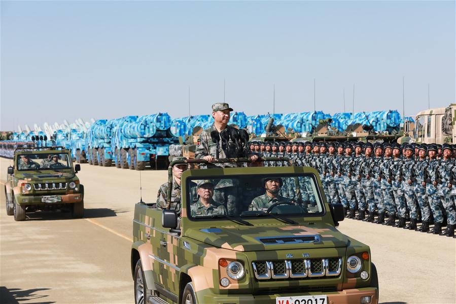 Xi reviews parade in field for first time