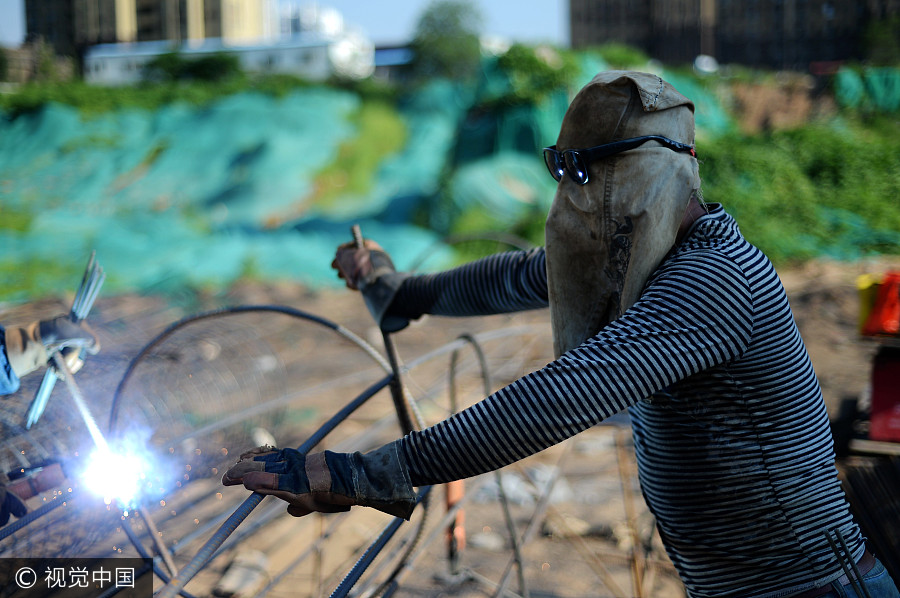 Welders cover up despite summer heat