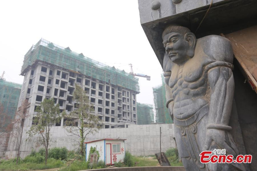 1,800-year-old temple under siege from high buildings in C China