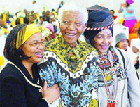 Nelson Mandela, center, with his wife Graca Machel, left, and his former wife Winnie Madikizela-Mandela, right. (AP Photo/Star, Debbie Yazbek)