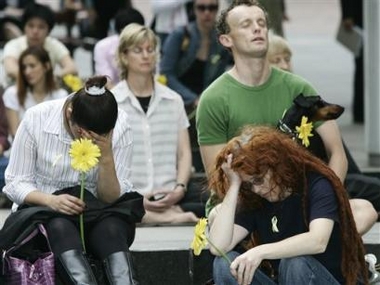 People hold a flower and weep for condemned drug smuggler Nguyen Tuong Van during a vigil in Sydney, Australia, Friday, Dec. 2, 2005, as they gather at the hour of his execution. 