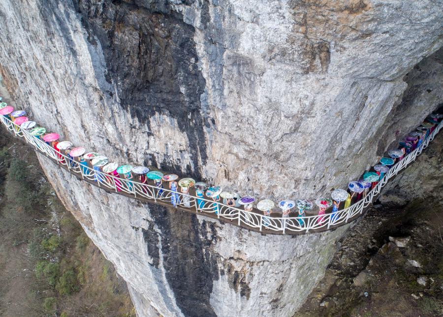 Qipao show presented on plank road built along vertical cliff in SW China