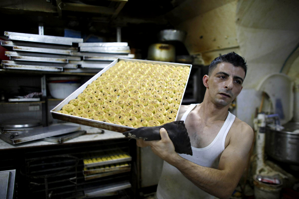 Workers prepare traditional cookies for Eid al-Fitr