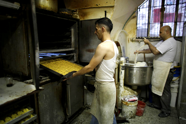 Workers prepare traditional cookies for Eid al-Fitr