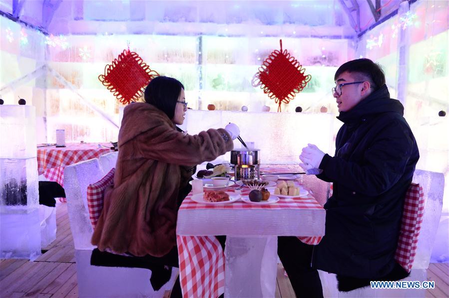 People enjoy meal in ice restaurant in NE China