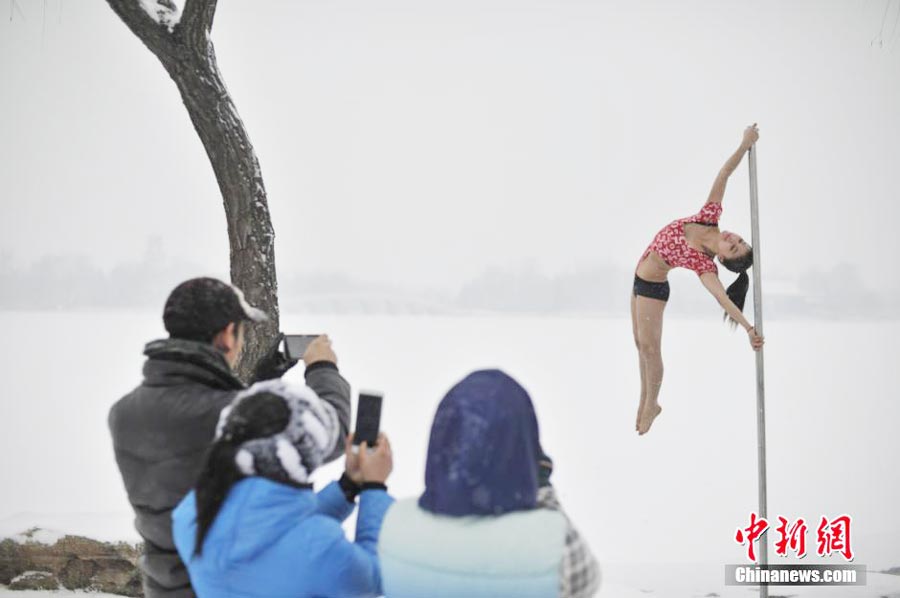 Pole dancers practice outside in cold winter