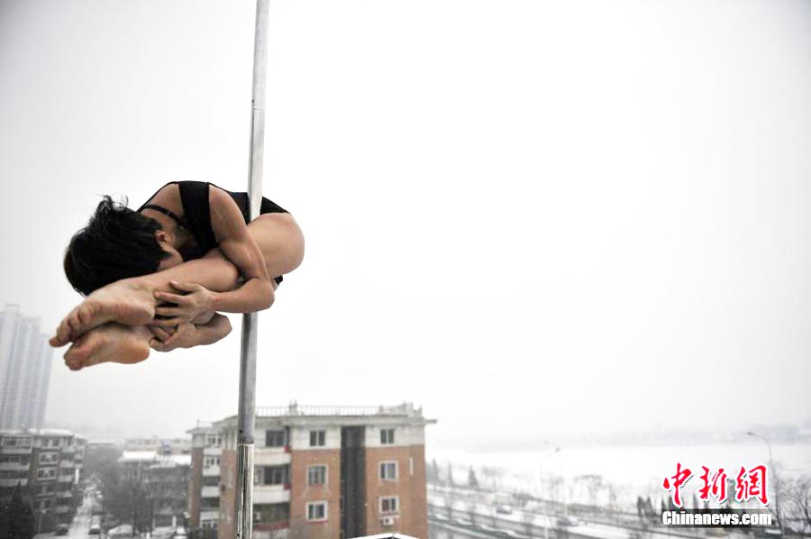 Pole dancers practice outside in cold winter