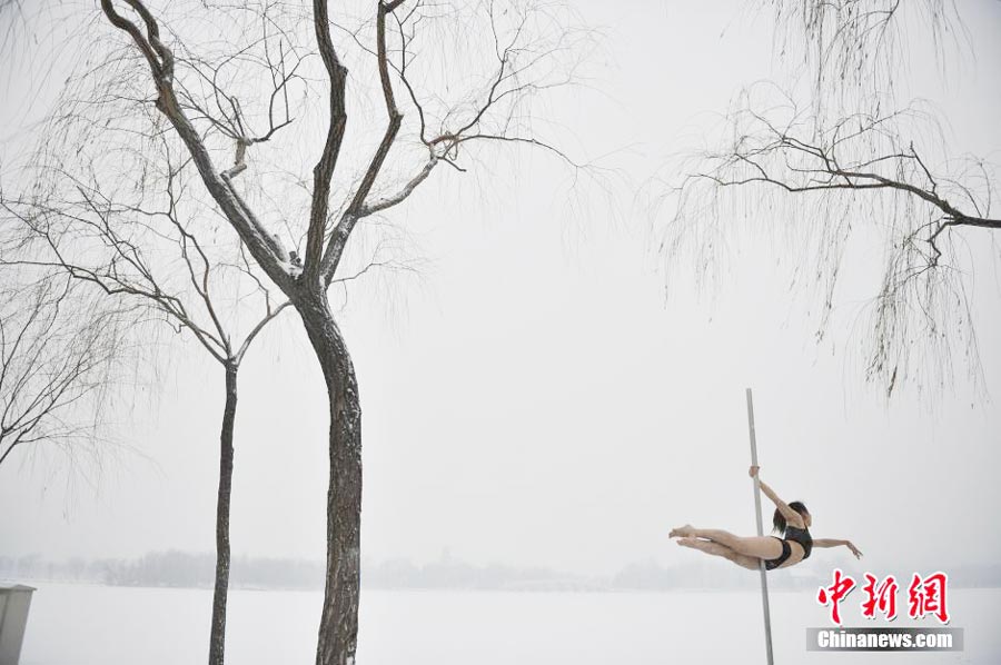 Pole dancers practice outside in cold winter