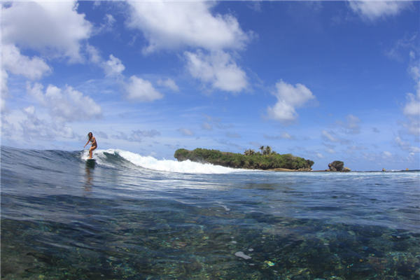 Female surfer rides China's waves