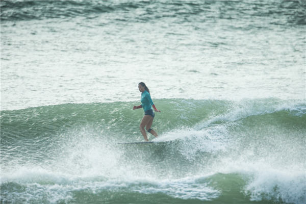 Female surfer rides China's waves