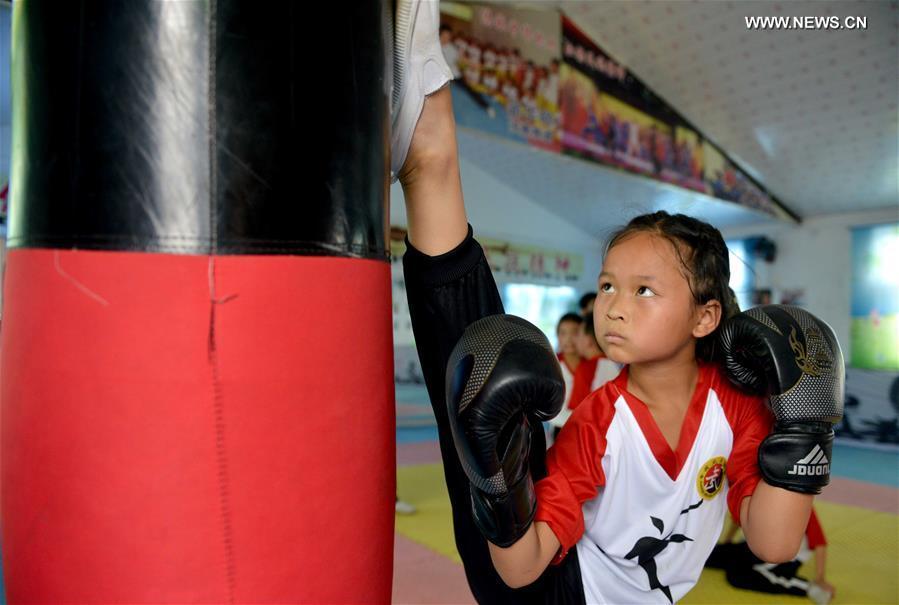 Children learn martial arts at training center in Henan province