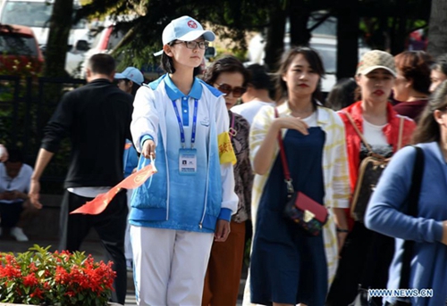 Volunteers seen on street in host city of 18th SCO Qingdao Summit