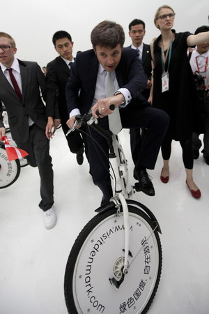 Denish crown prince rides a bike on Expo