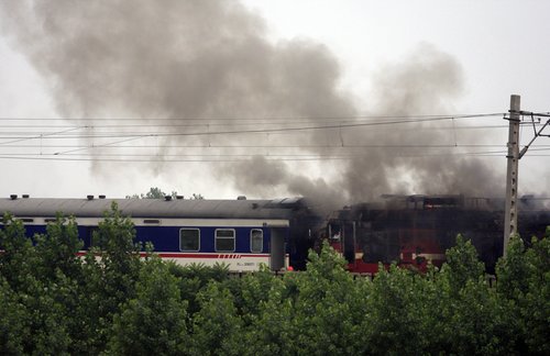 Moving passenger train catches fire in E. China