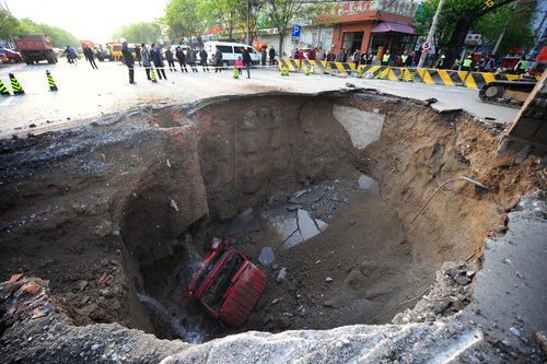 Road caves in, swallowing truck