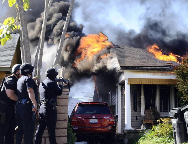 Los Angeles firefighters battle a house fire