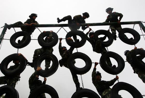 Armed policewomen train with soldiers