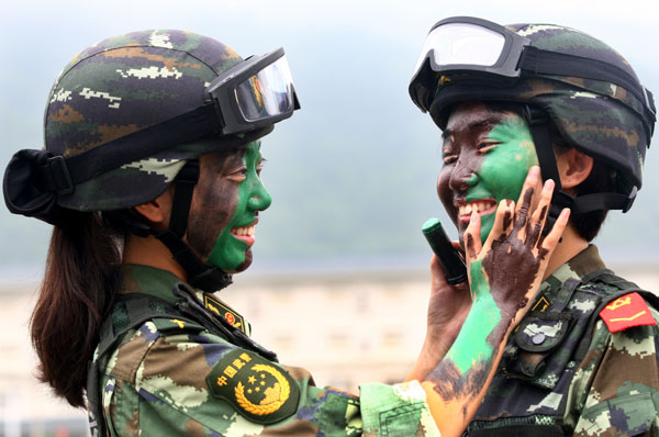 Armed policewomen train with soldiers