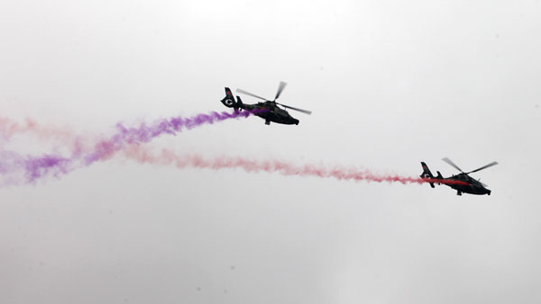 Helicopters practice acrobatic moves for expo