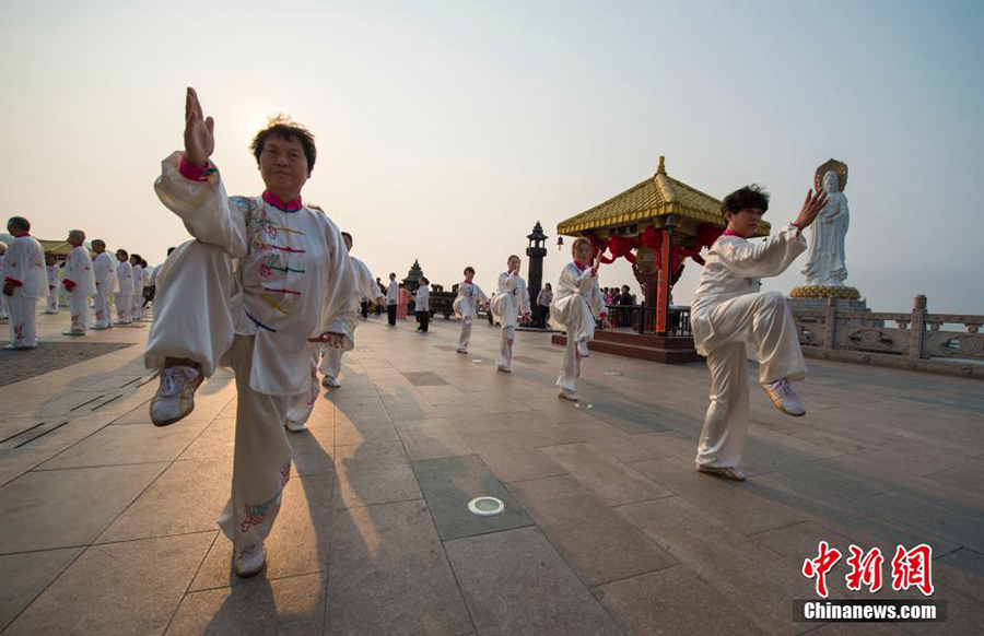 Hundreds of people practice tai chi in spring