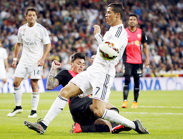 Real keeps heat on Barca after Almeria stroll