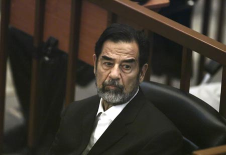 Former Iraqi President Saddam Hussein listens to prosecutors' statements during his trial in Baghdad's heavily fortified Green Zone October 30, 2006. 