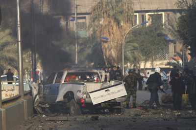 Smoke rises from a destroyed police vehicle shortly after a bomb attack in Baghdad, January 18, 2007. At least four people were killed and another 10 wounded on Thursday when a car bomb exploded in a busy street in central Baghdad, police sources said.