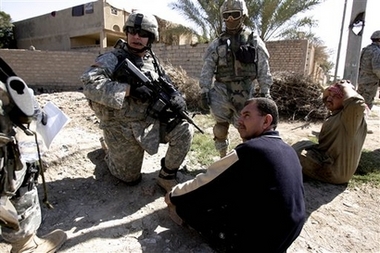 US soldiers of the 6-9 squadron, 3rd brigade, 1st Cavalry Division, briefly detain Iraqis as they inspect their car in Muqdadiyah, Iraq, 90 kilometers (60 miles) north of Baghdad, Wednesday, March 7, 2007, during a routine patrol. (AP