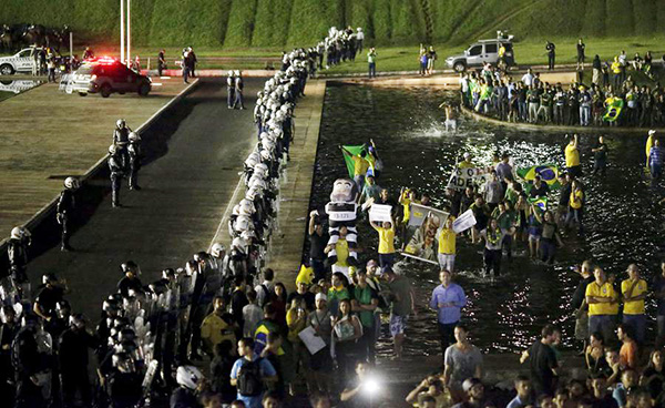 Brazil's Lula sworn in over protests as Rousseff faces impeachment