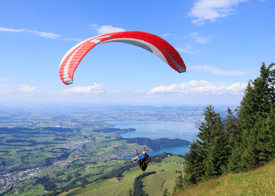 Paragliding fans fly over Rigi mountain in Switzerland